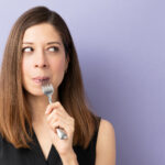 woman eating some food with a fork