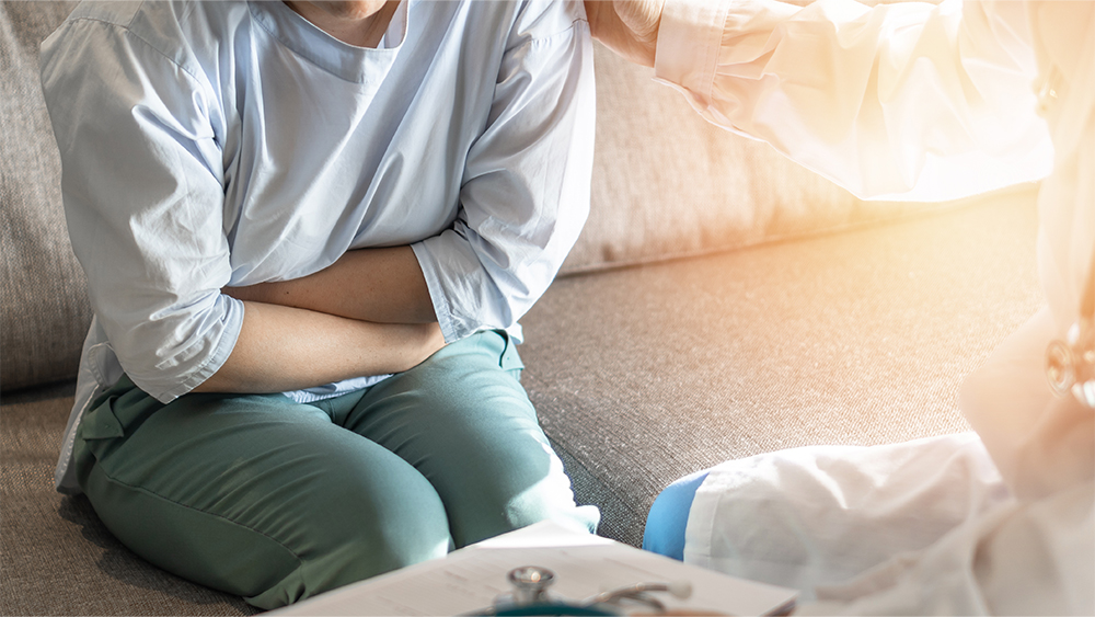 Abdominal pain patient woman having medical exam with doctor