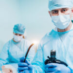 Diagnosing Crohn’s disease with a colonoscopy, surgeon holds a colonocope in his hand