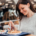 Treatment options for GORD blog image, woman eating pasta.