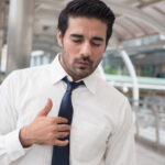 Image for the importance of diagnosing GORD blog. Man with hand on chest.